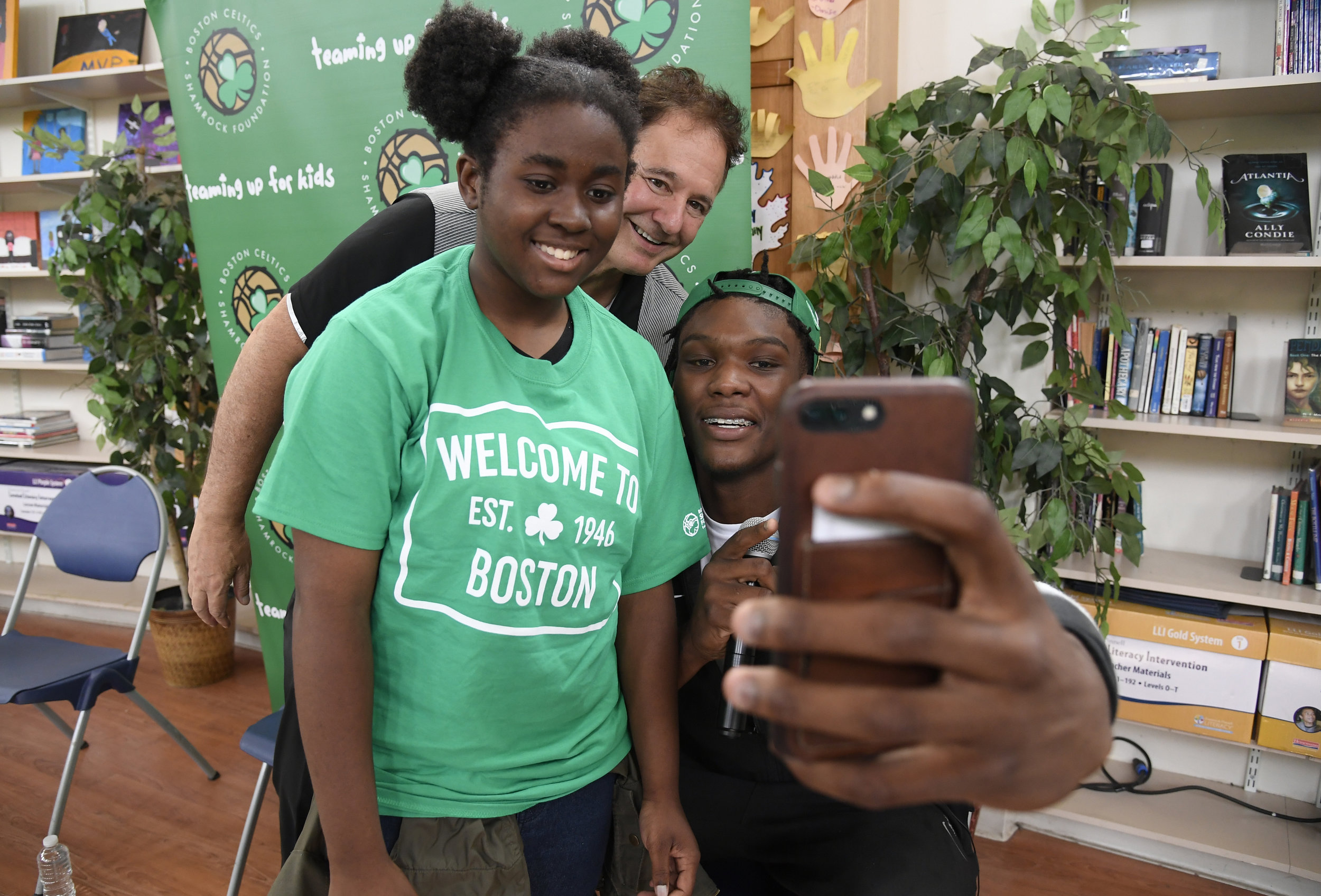   Robert Williams, the 2018 Celtics Rookie, taking a selfie with Ashanti and Stephen Pagliuca  