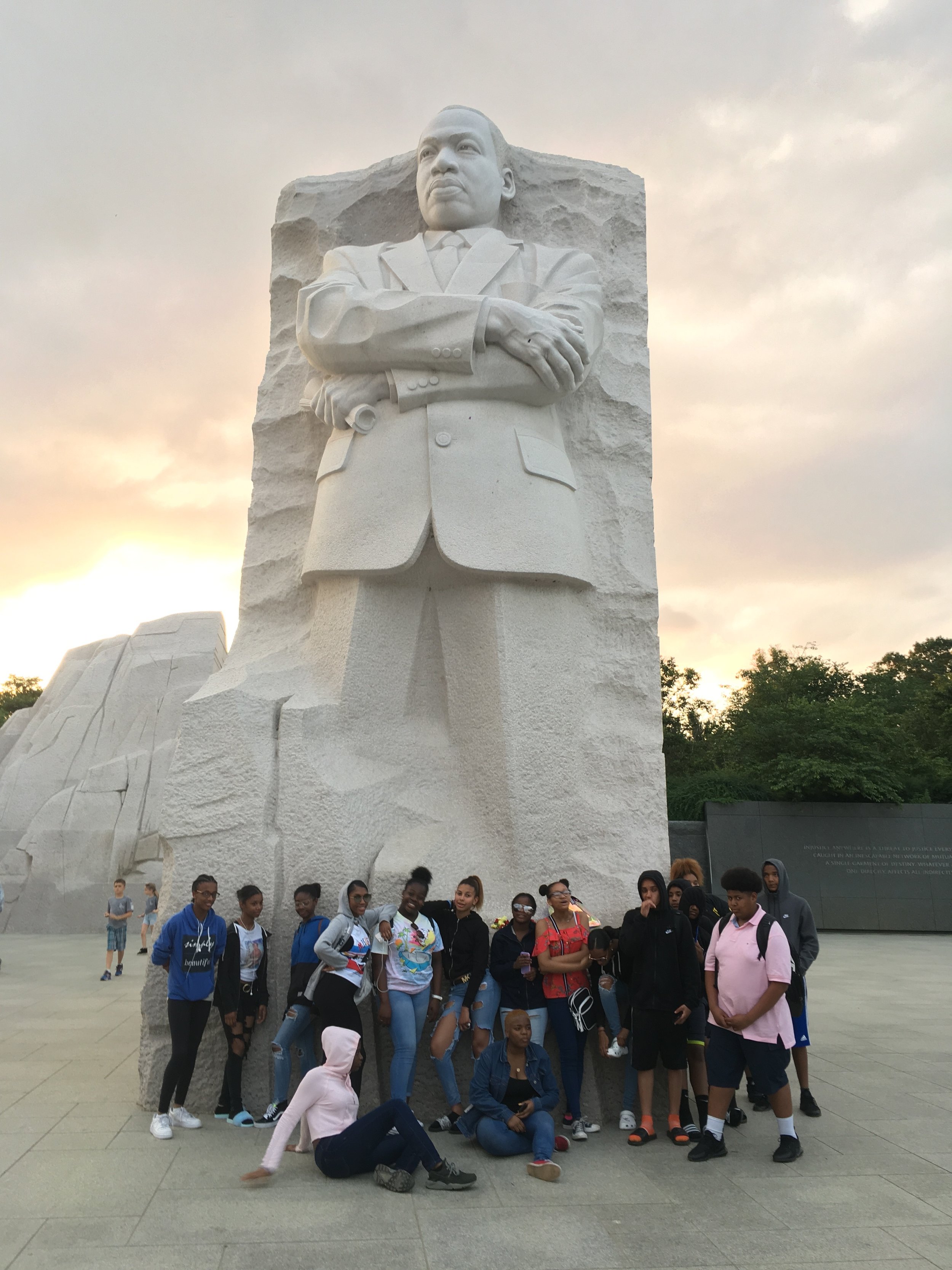   Posing with Dr. Martin Luther King, Jr.’s statue  