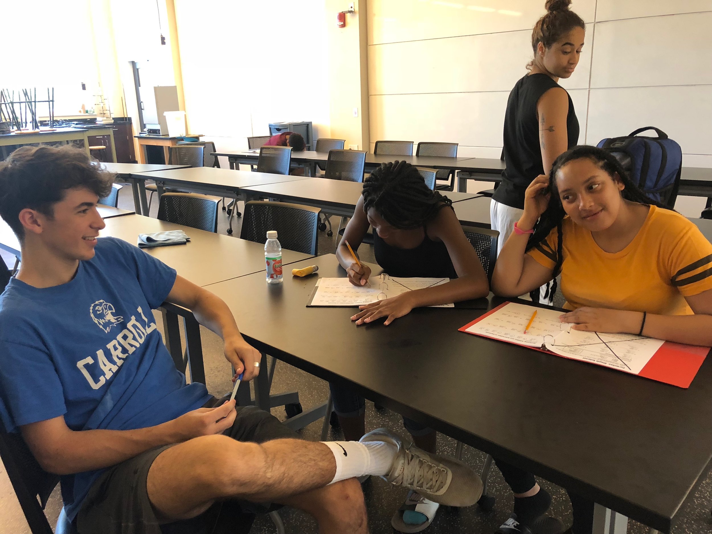   Counselor helping Nijah and Naomi with their math homework  