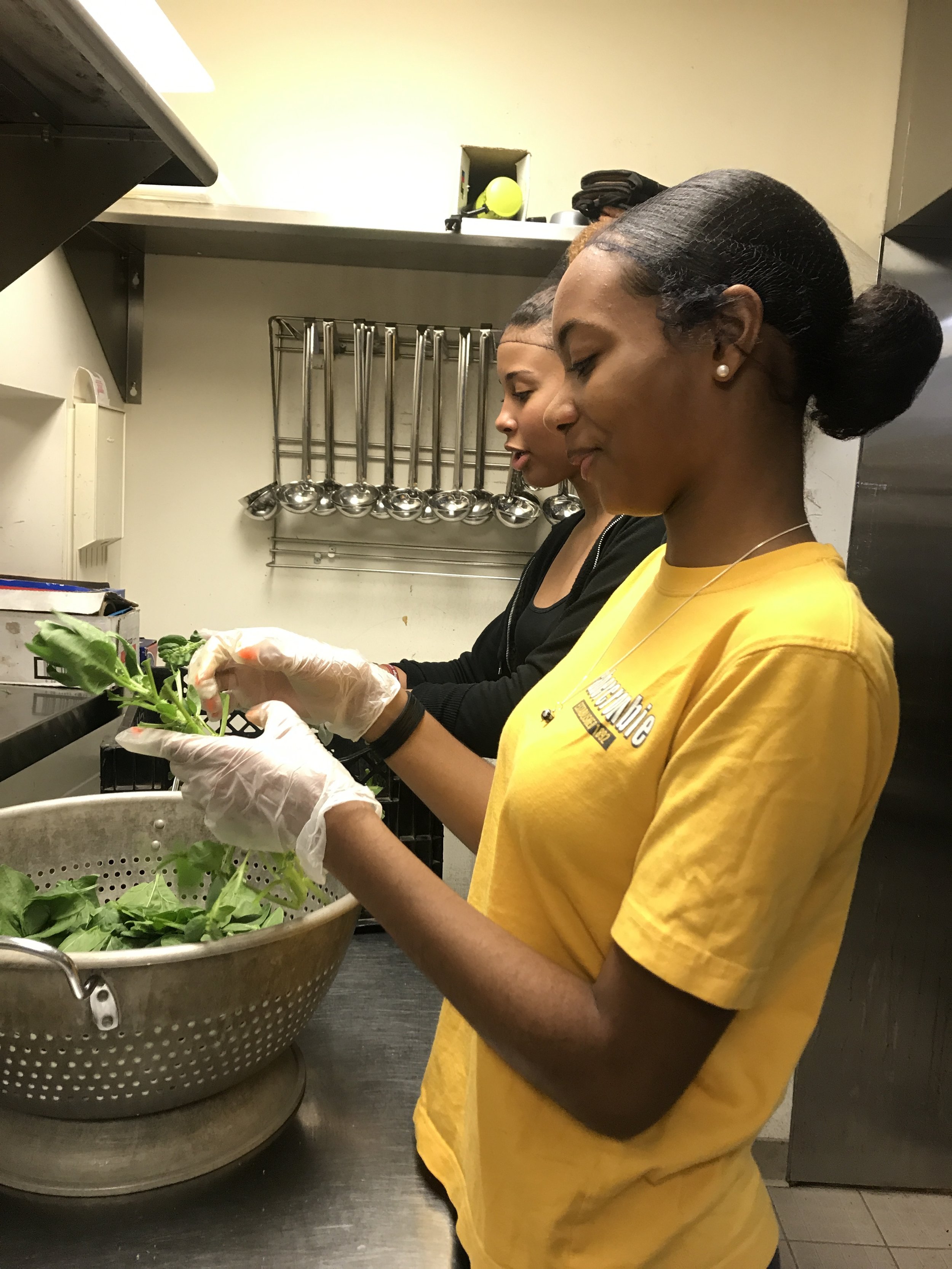   Nerville ‘18 and Juliana ‘18 cutting the kale.  