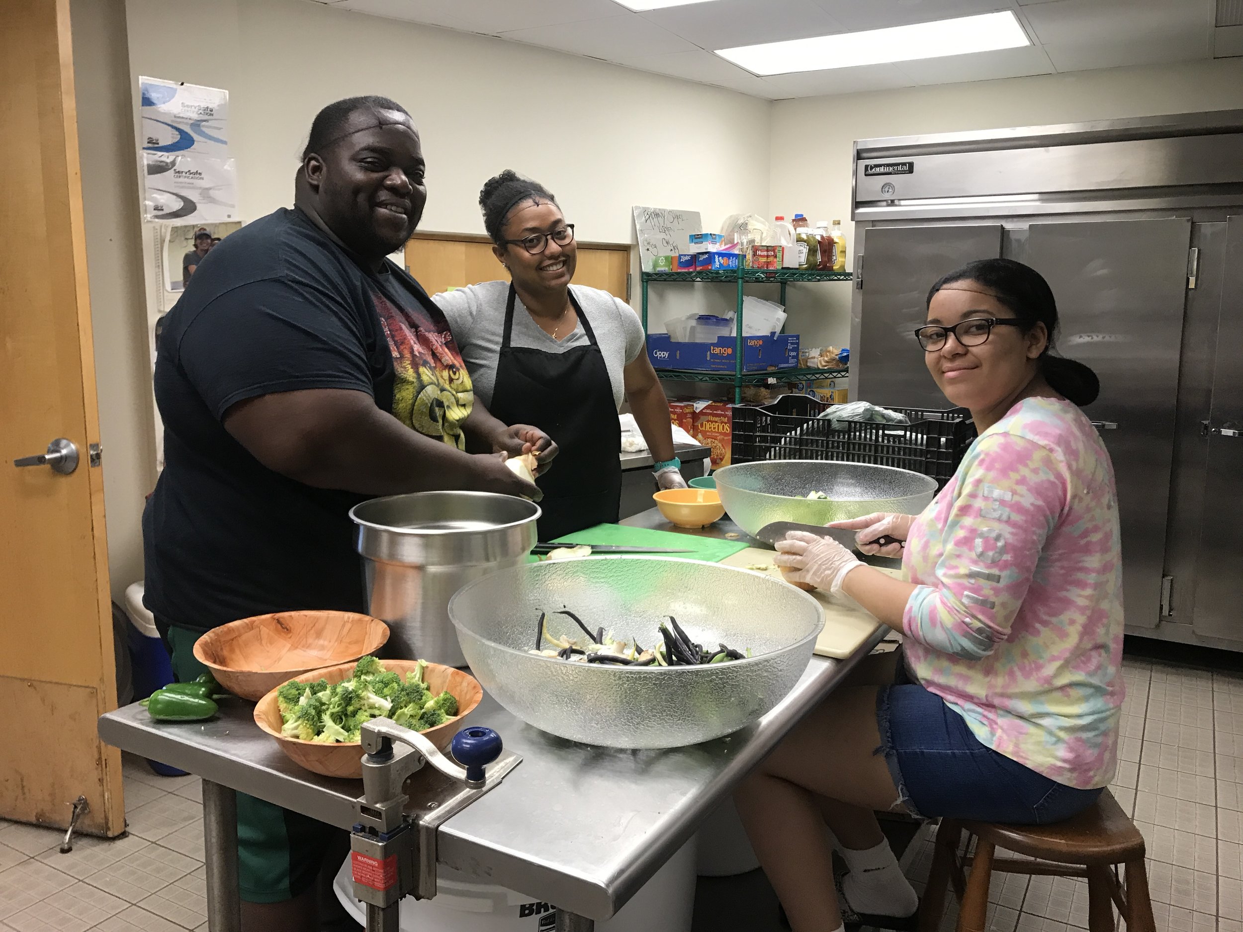   Chef Tey, Sabrina ‘08 and Jorelys ‘17 preparing the ingredients.  