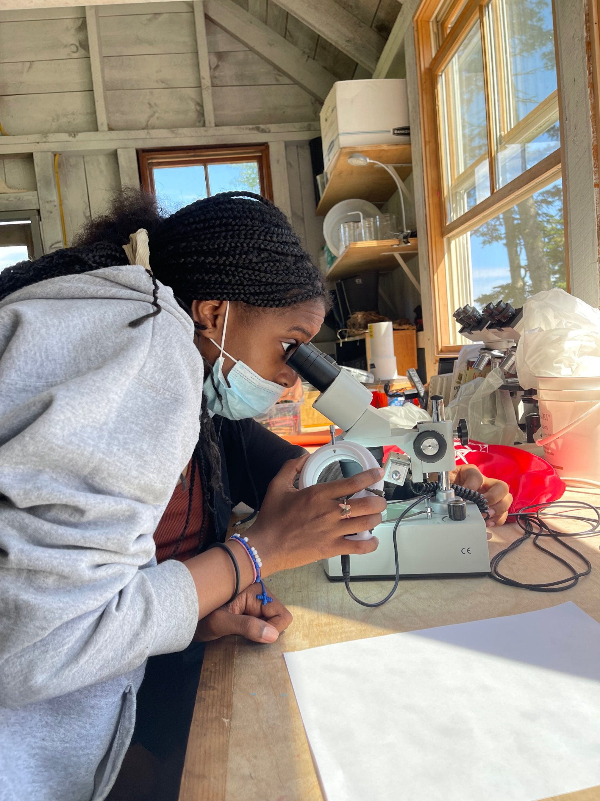  Zakiya looking though the microscope. 