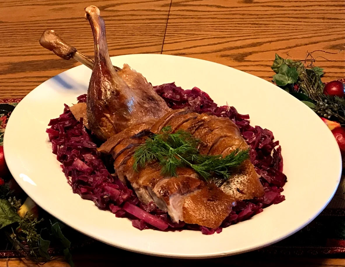 Roast goose on a bed of braised red cabbage.