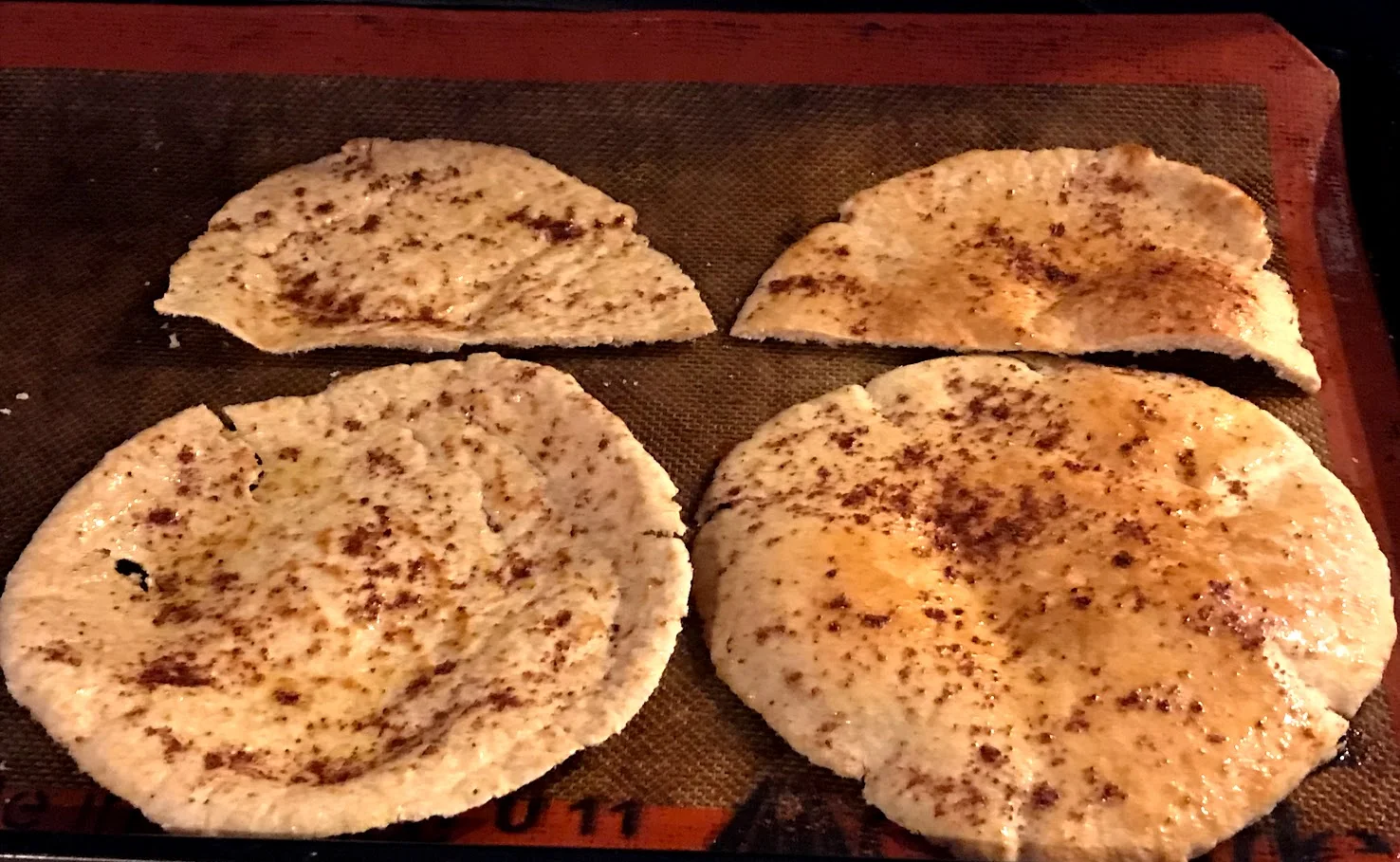 Pita bread, sliced in half through the middle of each round and oven-ready.