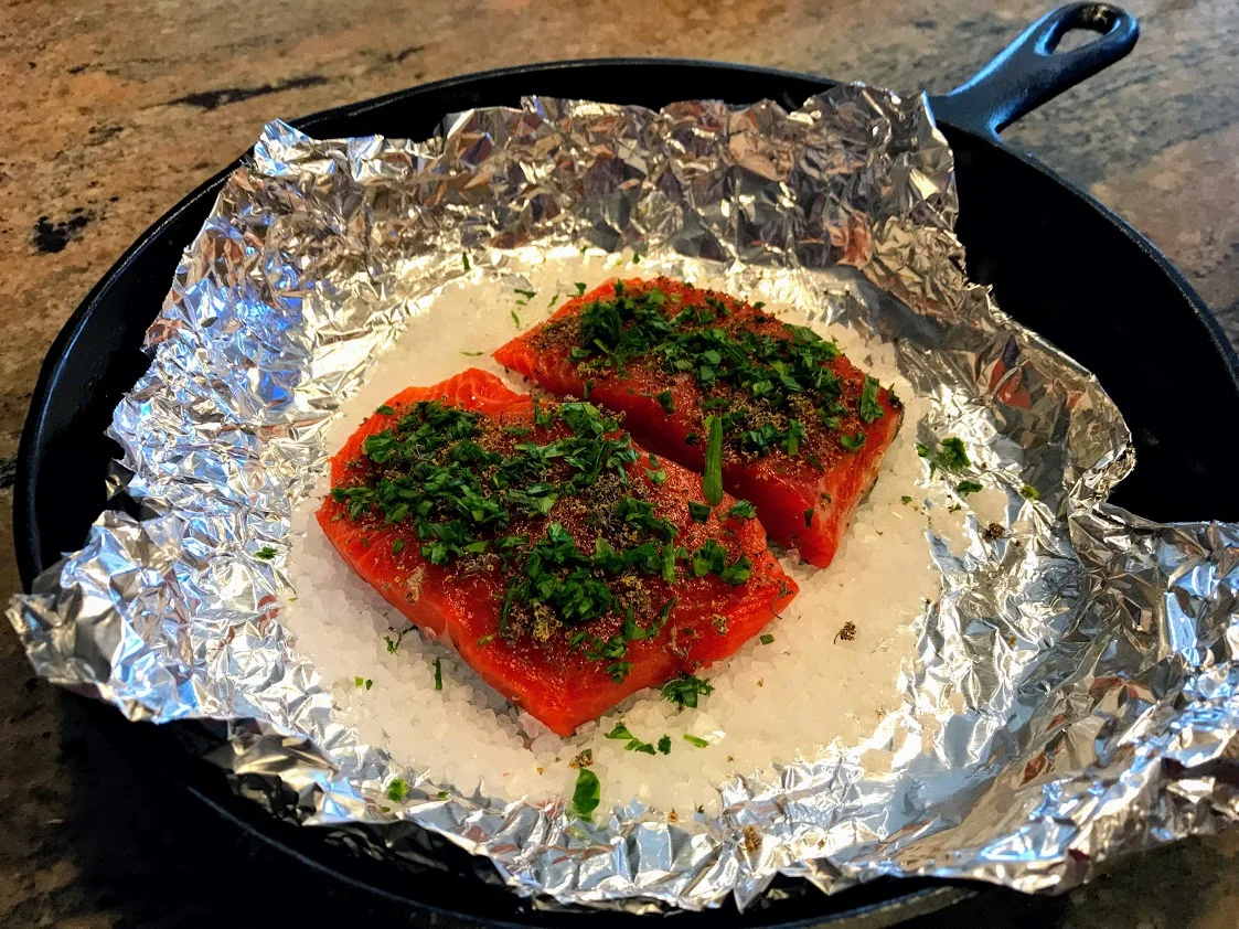 Salmon on a bed of rock salt (or kosher)