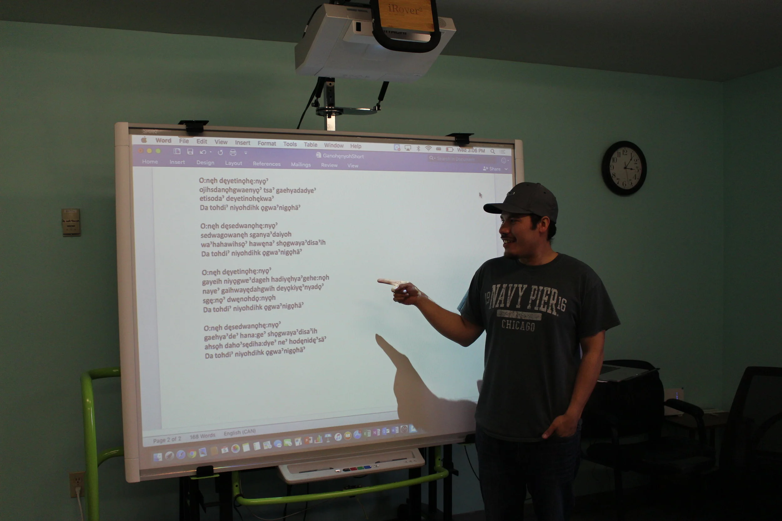 Instructor and Program Manager Ely Longboat teaches a lesson using a SMART board.