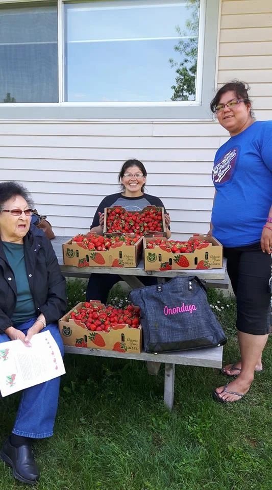 Our students go berry picking with one of our elders.