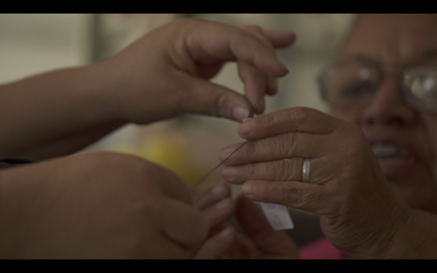 The mothers embroidering the name of their missing daughters , 2016 / Still from film / Credit: Lise Bjørne Linnert 