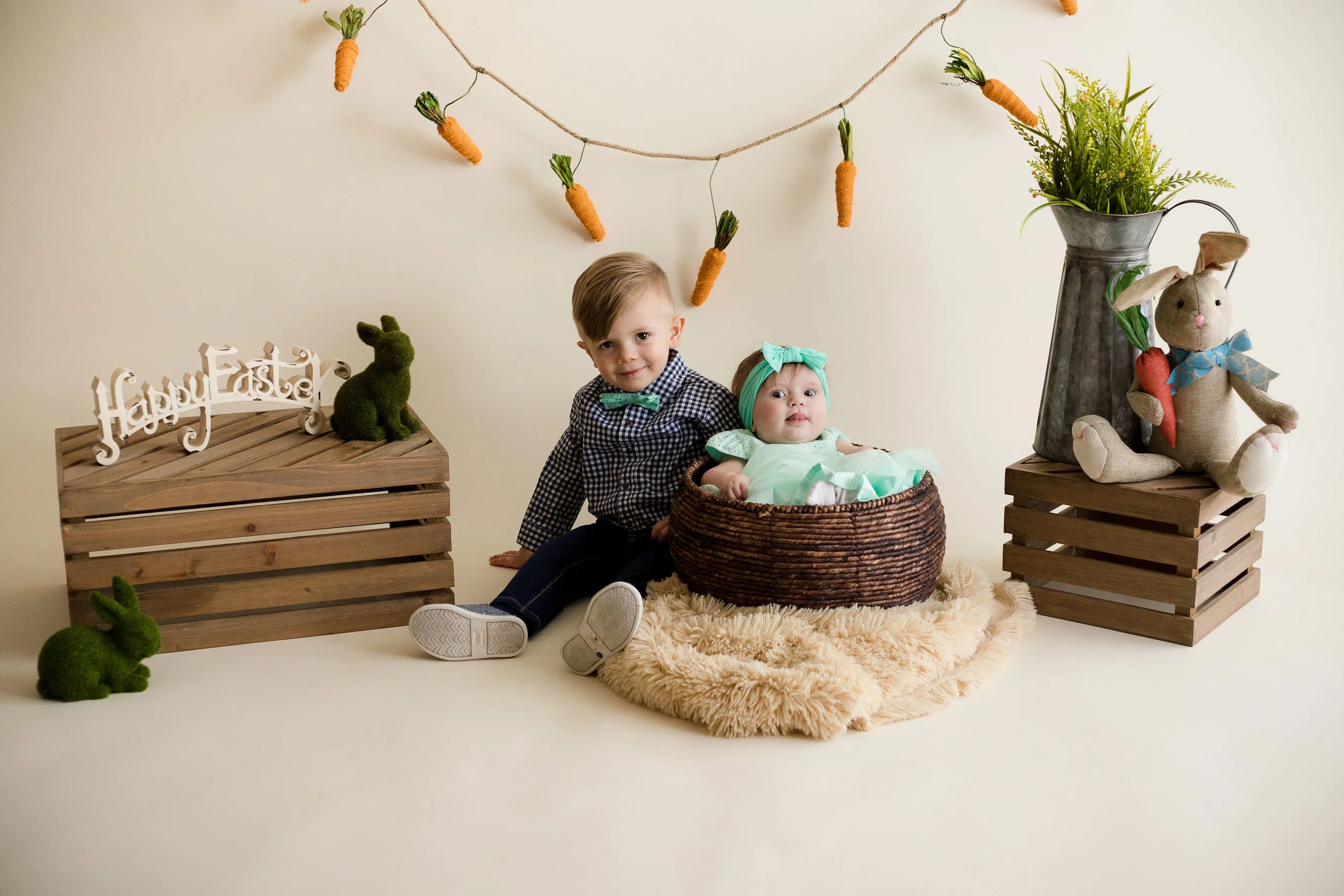 Two year old boy and five month old girl sitting for picture during Easter Mini Session in Cedar Rapids, Iowa. 