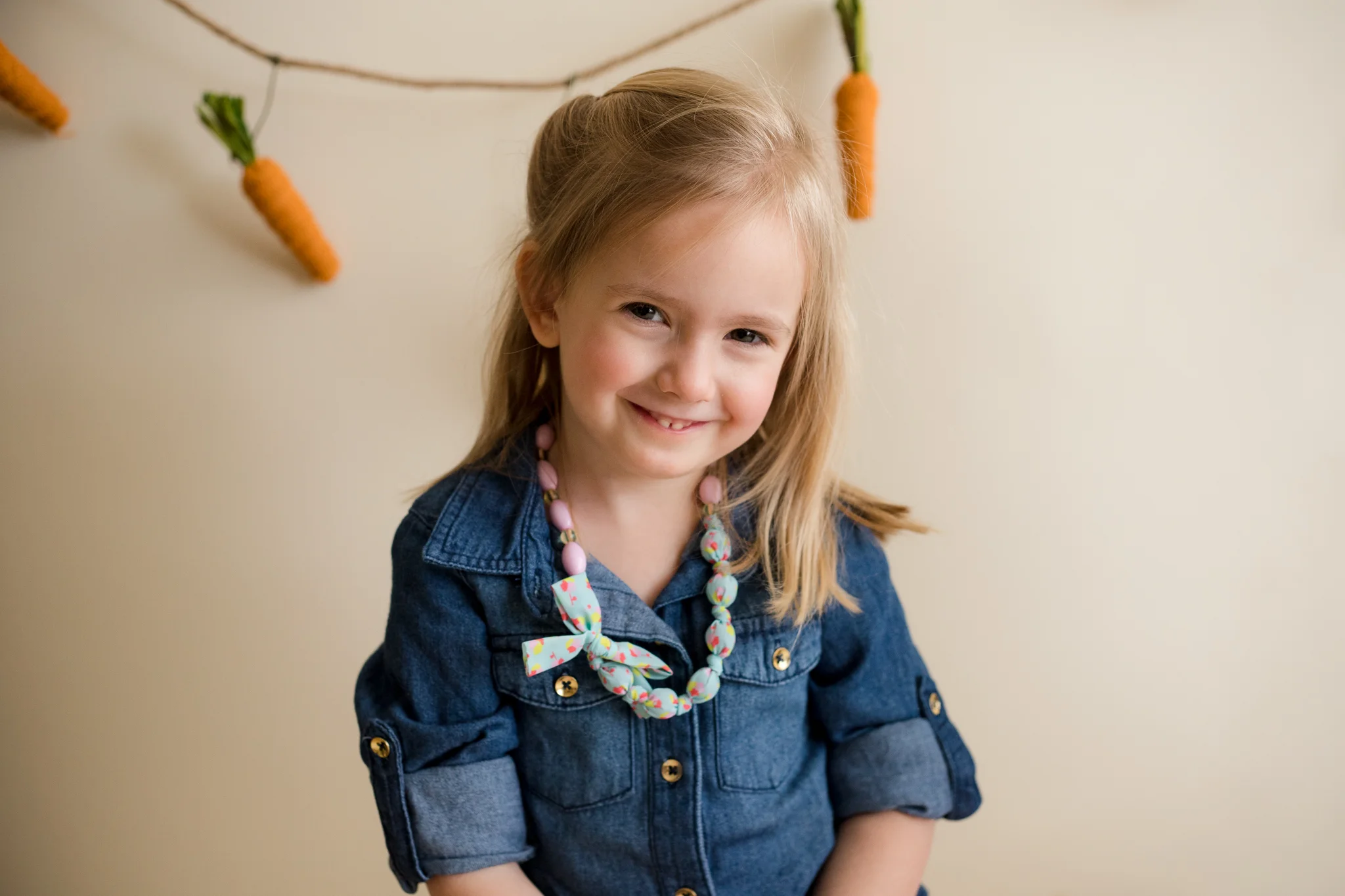Three year old girl sitting and posing for a photo in Cedar Rapids. 