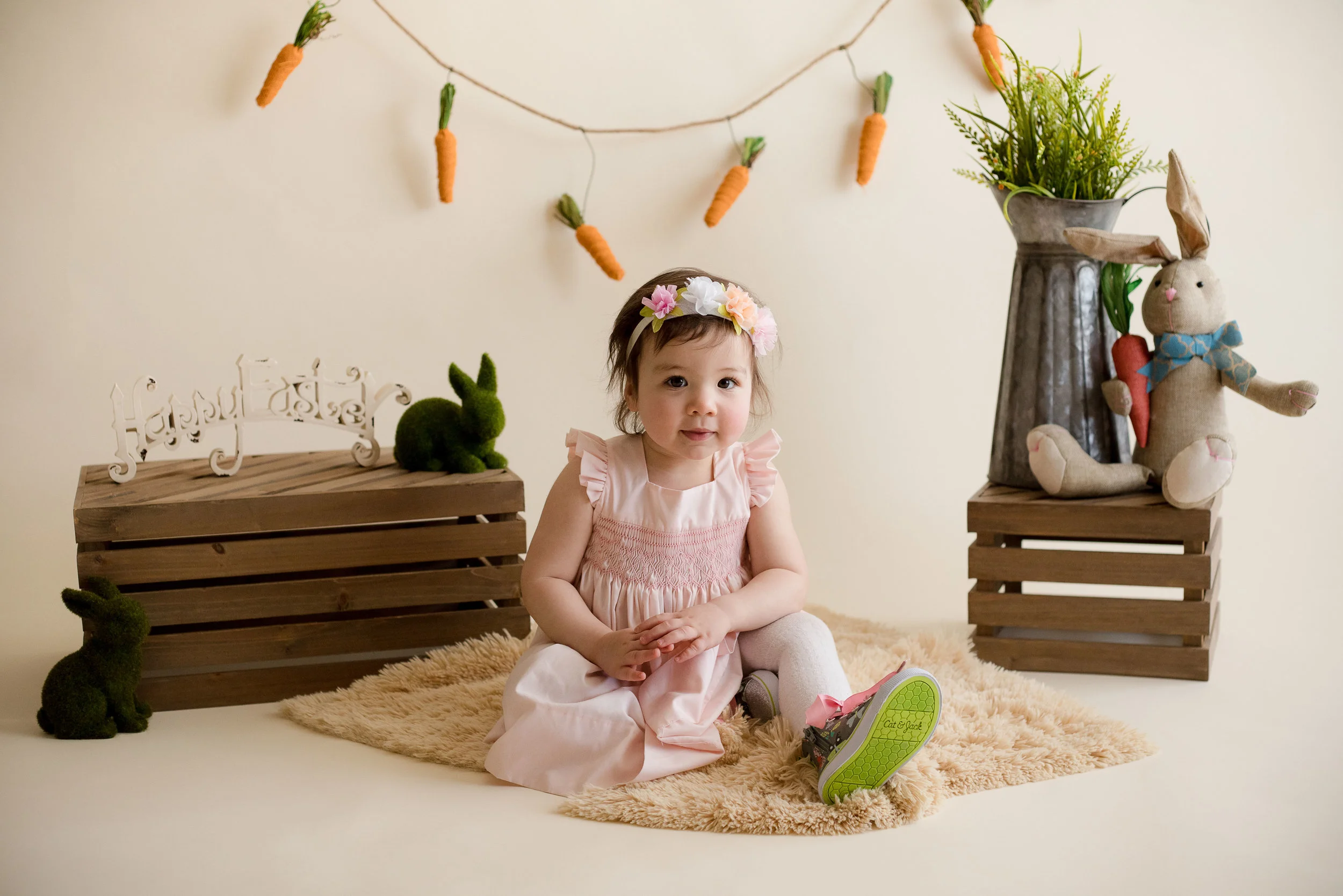 One year old girl sitting and looking at camera. 
