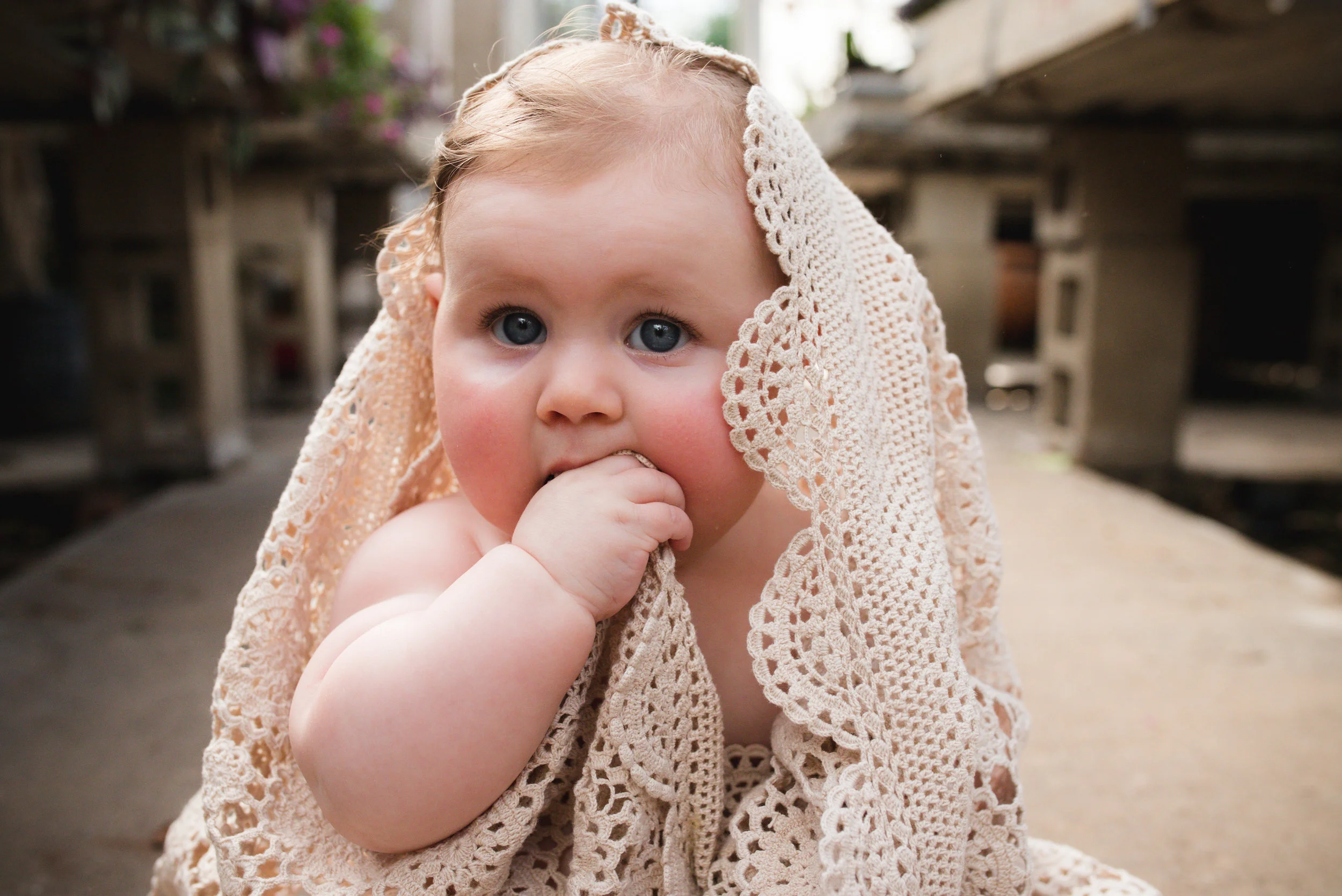 Doily blanket over baby girl in Iowa. 