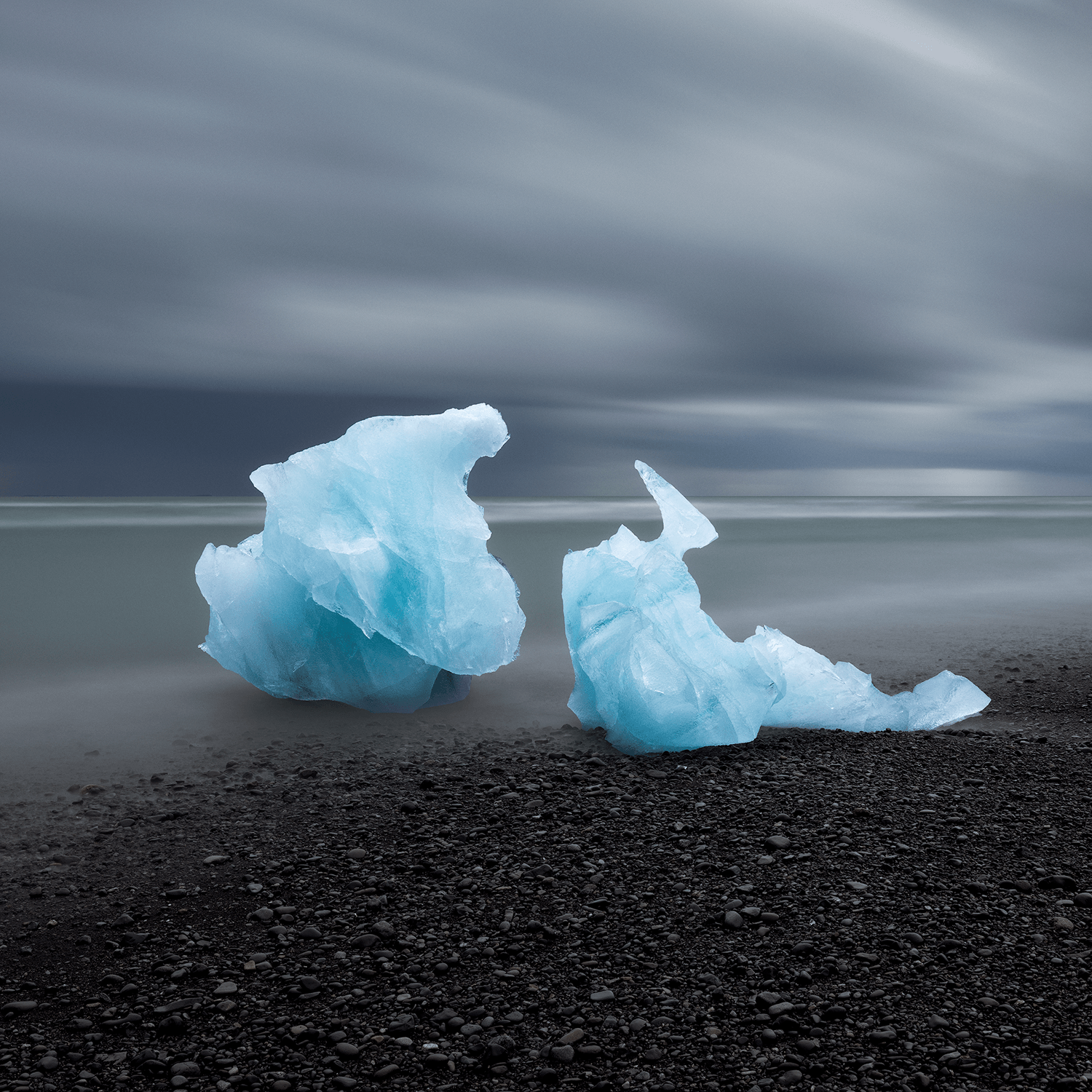 Blue ice formations resting on black sand beach in Iceland