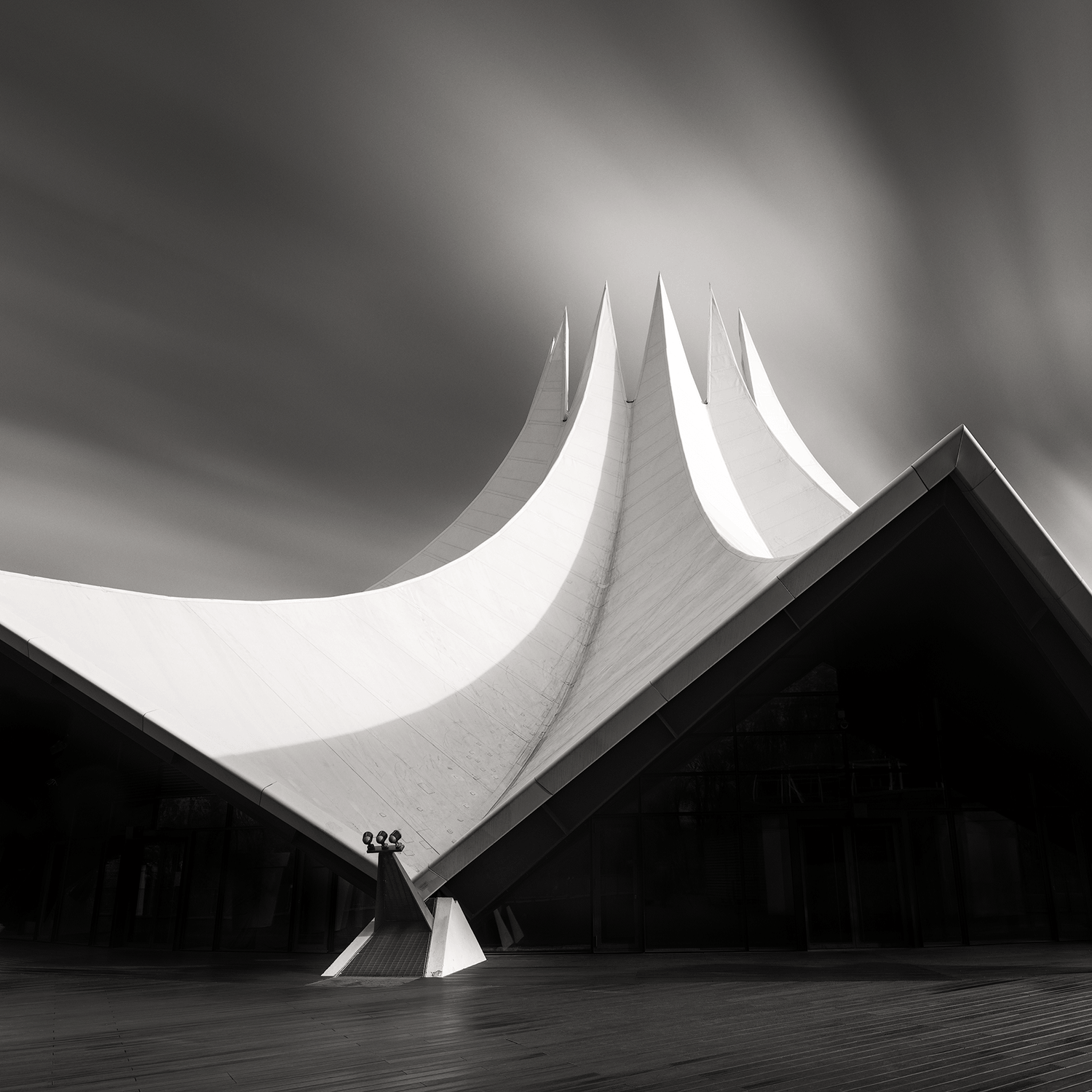 Modern architectural structure with sweeping lines in black and white