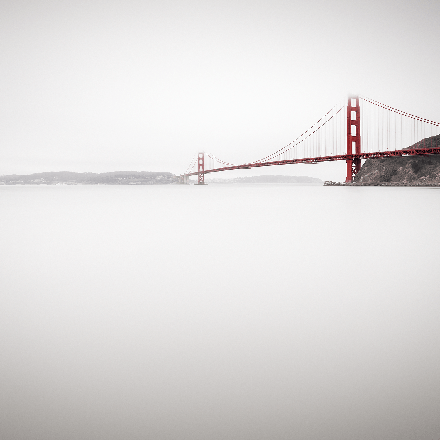Golden Gate Bridge partially obscured by fog in long exposure