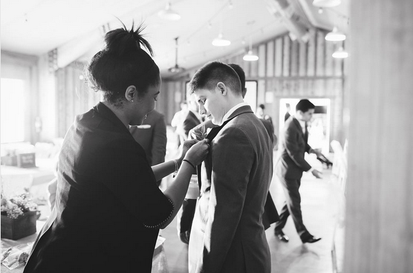 Something to celebrate intern assists groomsman with boutonniere