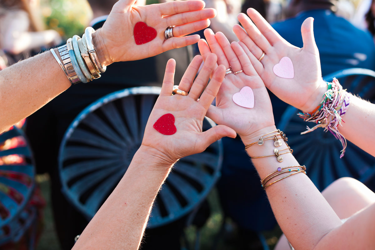 As a surprise for the bride and groom, Karen asked us to help the guests each get a felt heart for their palm. At the end of the ceremony, the guests held their palms up toward the bride and grooms, revealing their hearts (and a subtle nod to the Hunger Games).