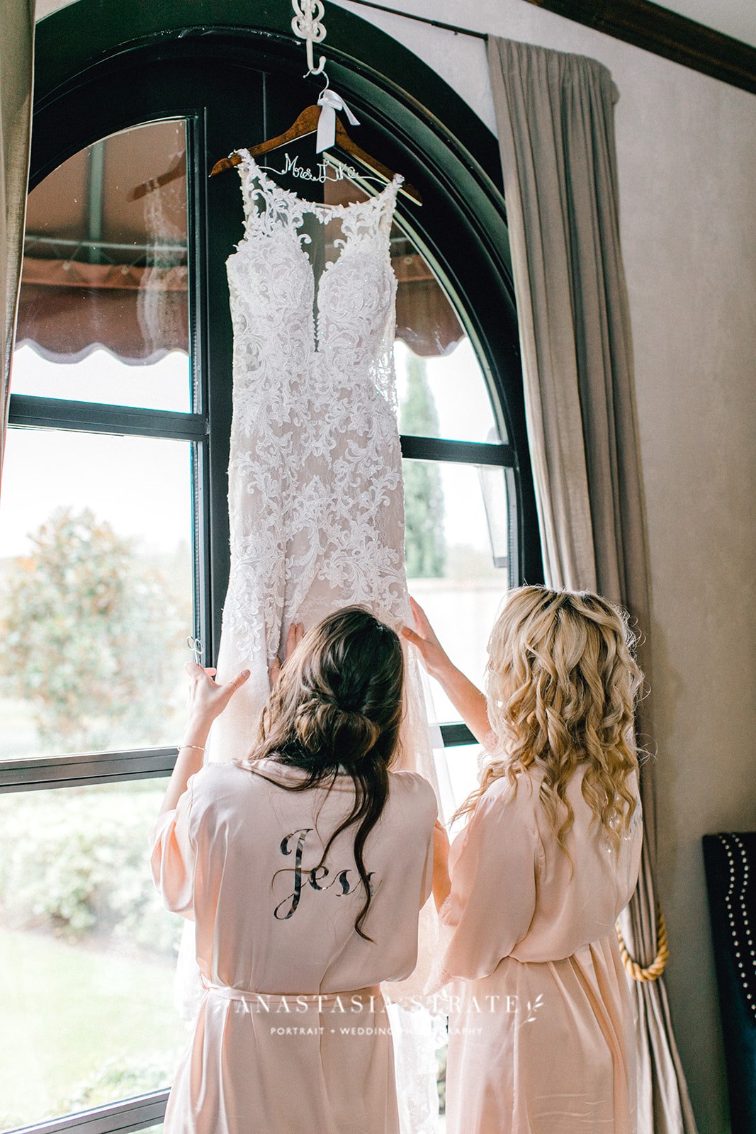  wedding dress hung by the window   
