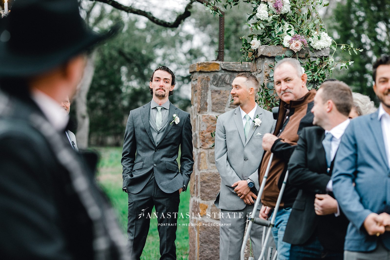  groom watching her bride walk down the aisle 