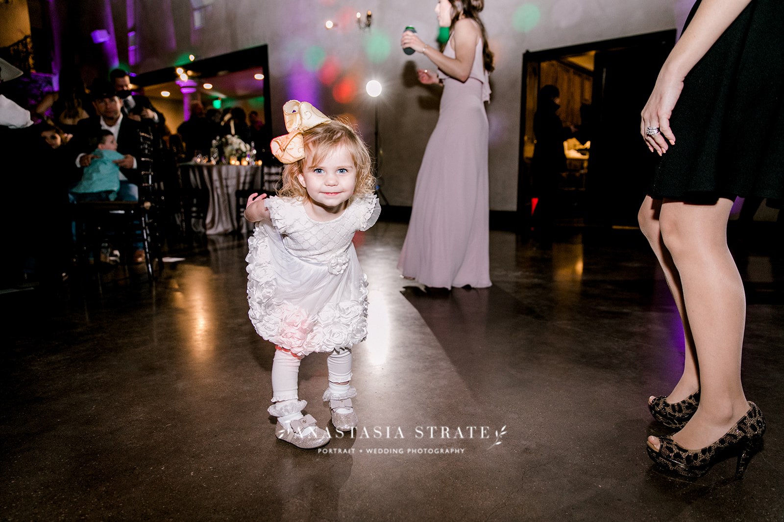little girl dancing at the wedding reception