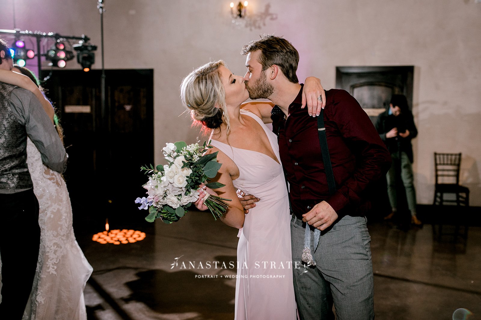 bride and groom kiss at their wedding reception