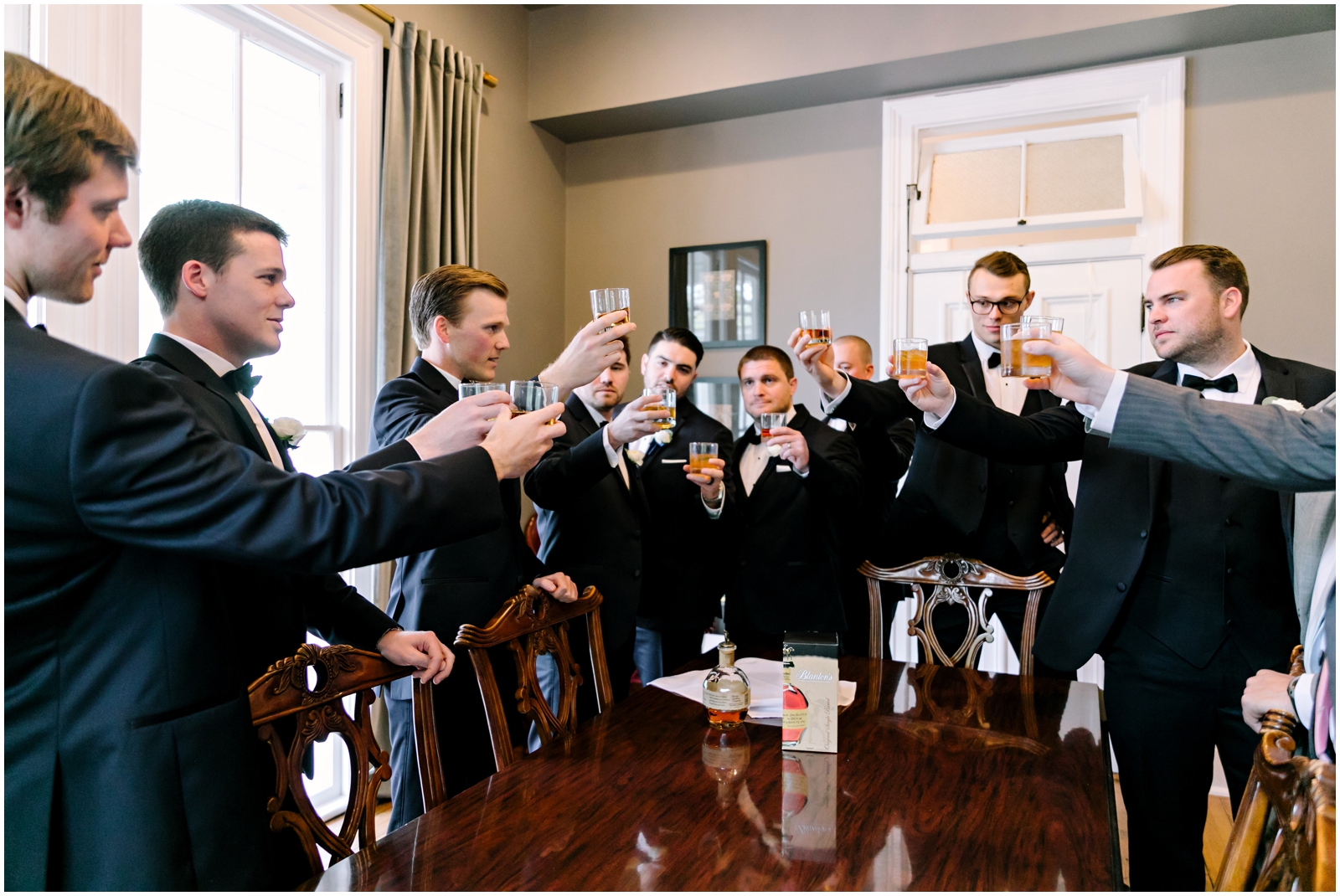 Groomsmen and groom making a toast before the wedding
