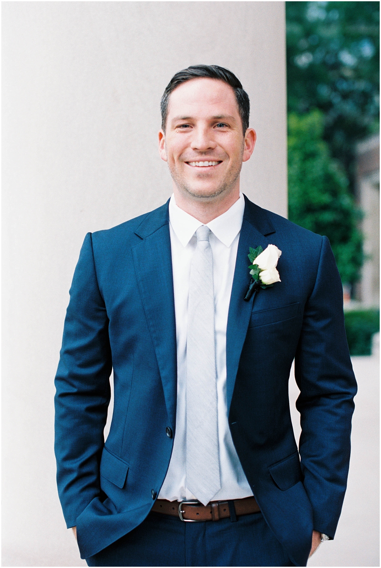  groom wearing a navy suit and boutonniere 