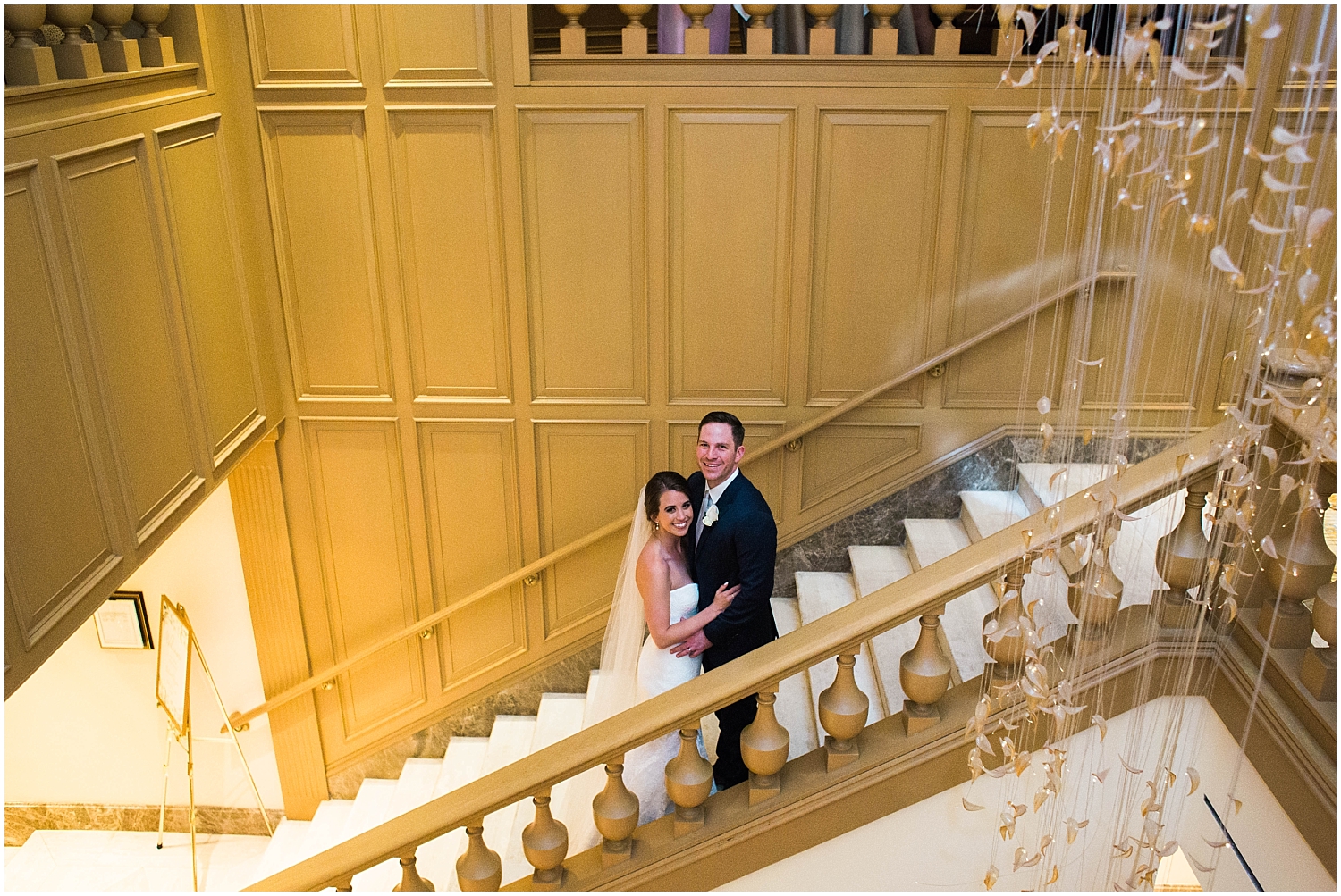  bride and groom standing in a stair well 