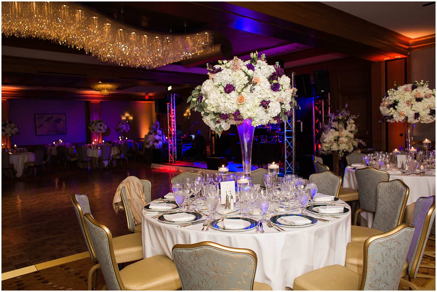 tall wedding centerpiece with purple and white flowers