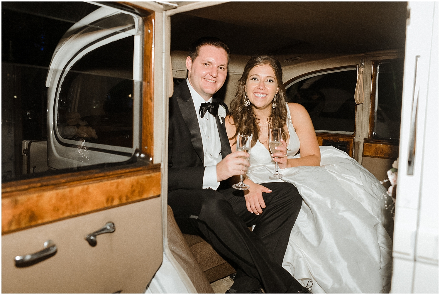  bride and groom leave in a vintage car  