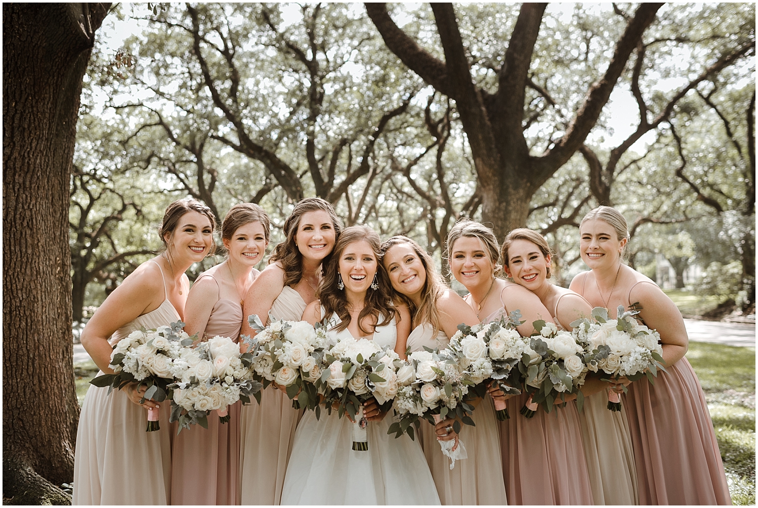  bride and the bridesmaids holding their wedding bouquets 