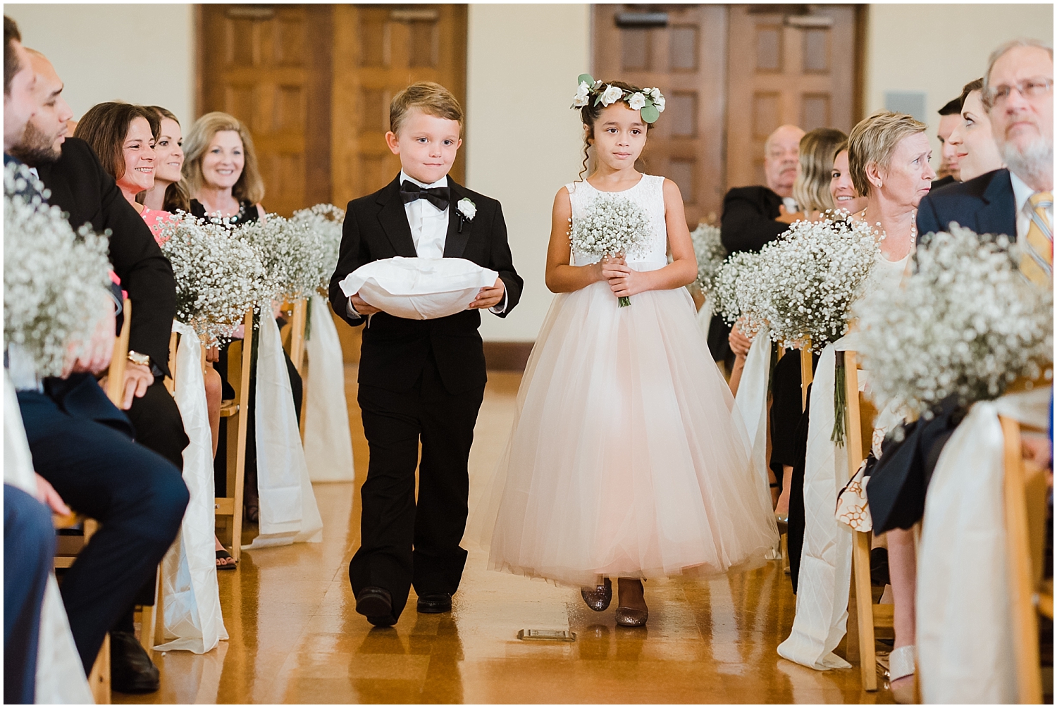  flower girl and ring bearer walk down the aisle 