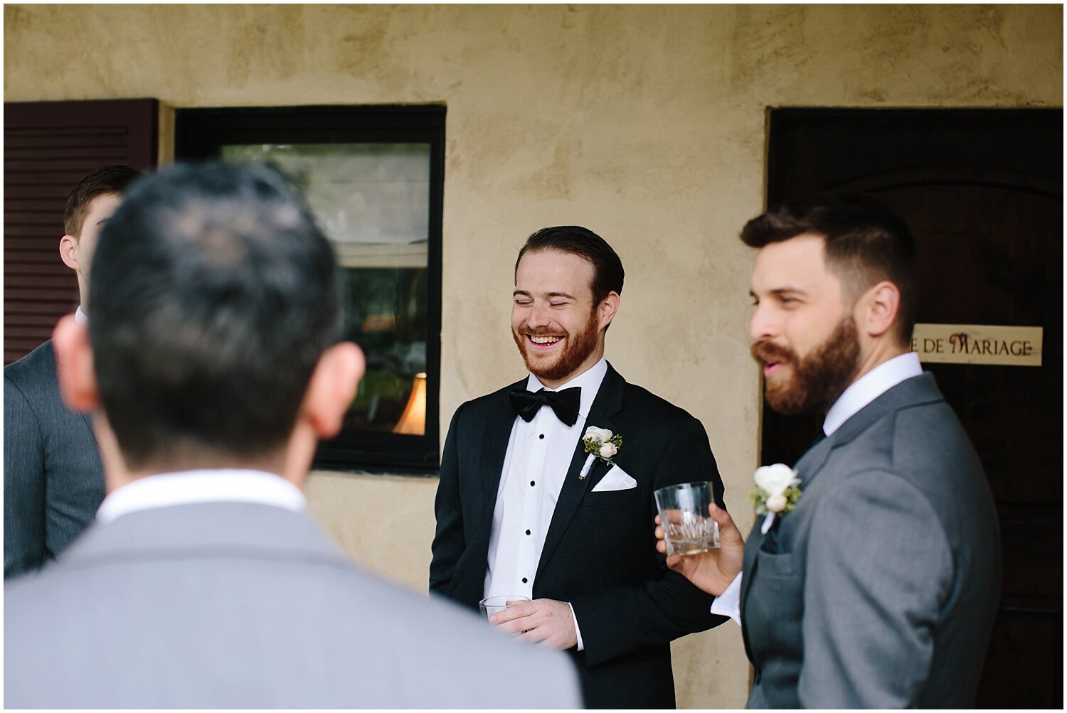  groom with the groomsmen laughing 