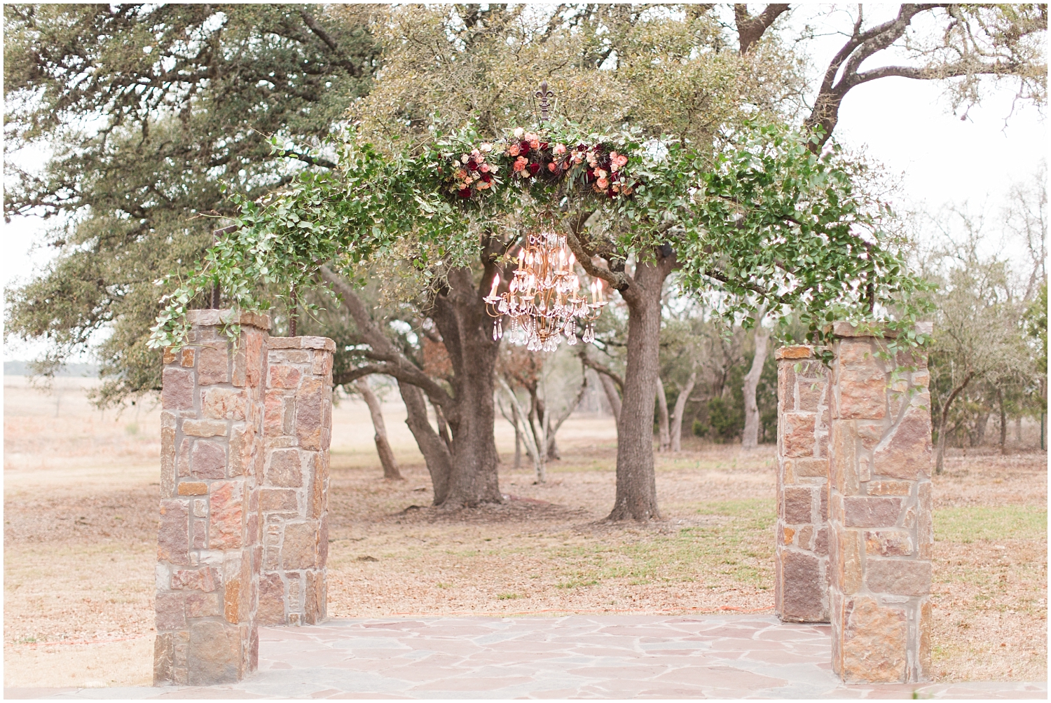  wedding arch with a chandelier and flowers 