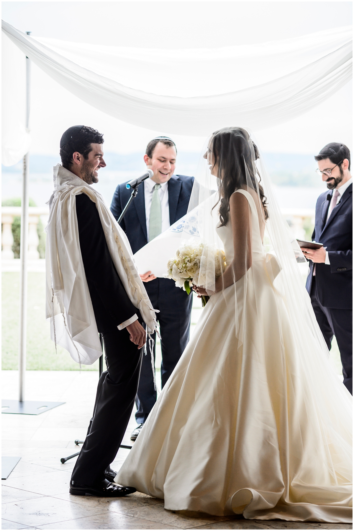  bride and groom smiling during their wedding ceremony 