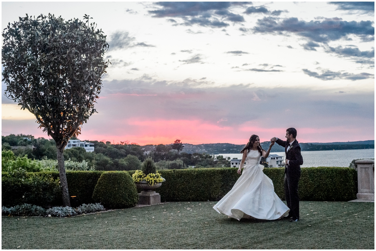  bride and groom dance during sunset 
