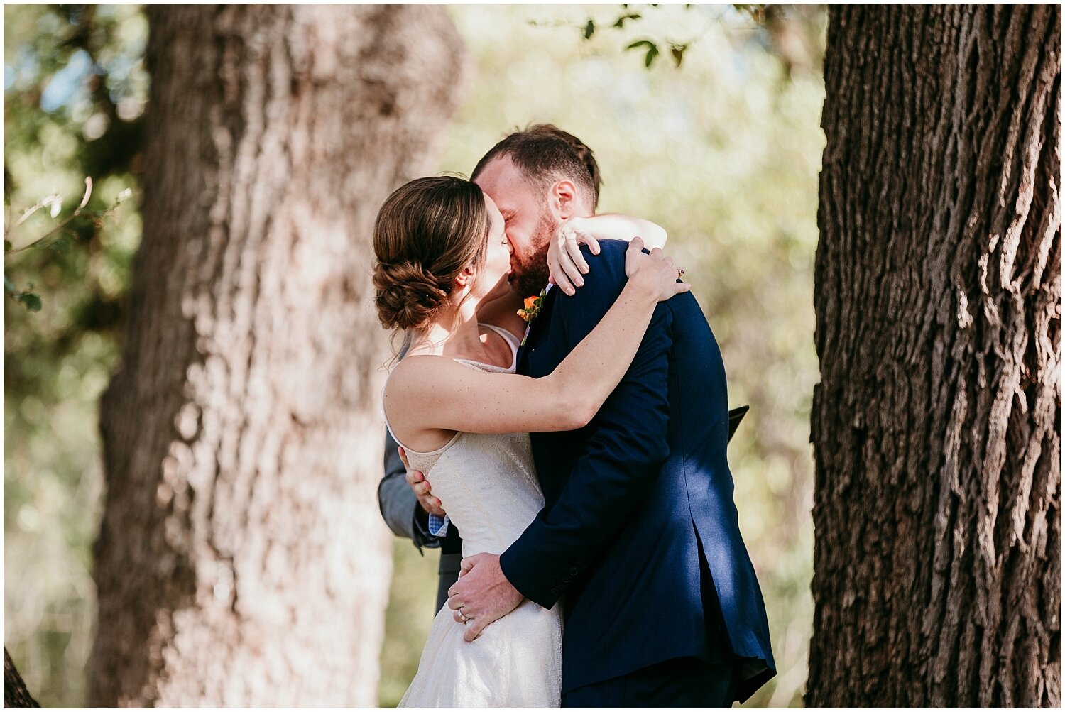  bride and groom kiss at their outdoor wedding ceremony 