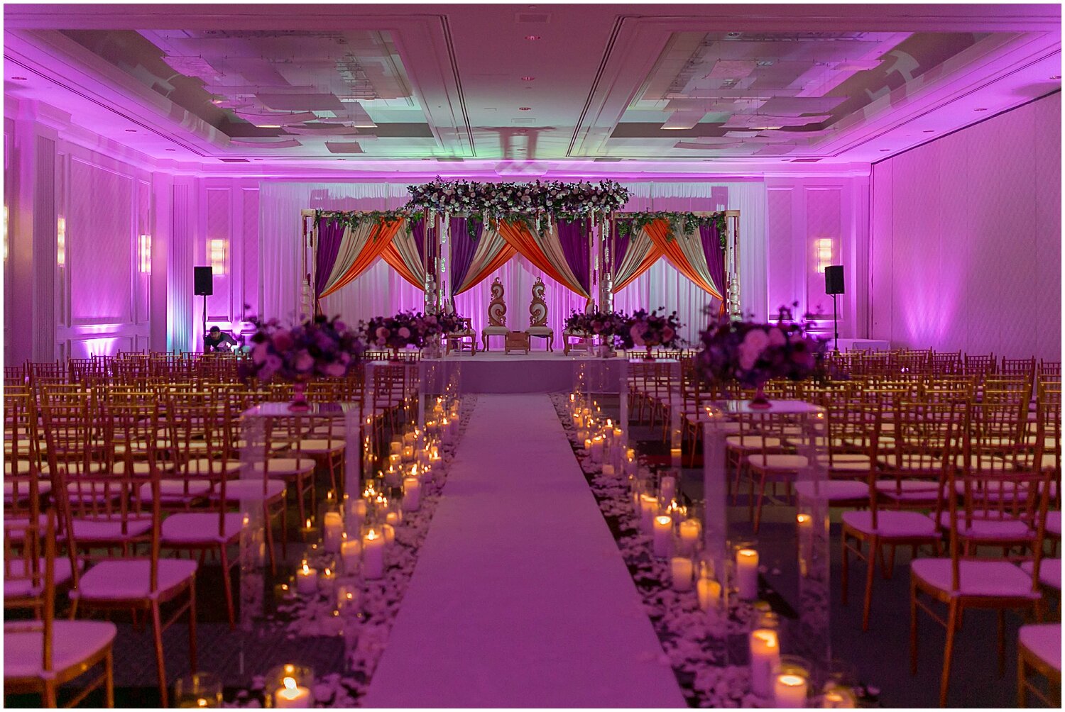  Candlelights in the aisle for wedding ceremony and purple lighting 
