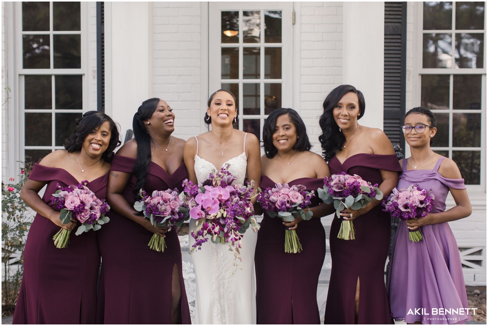  bridesmaids wearing lavender dresses and holding bridal bouquets 