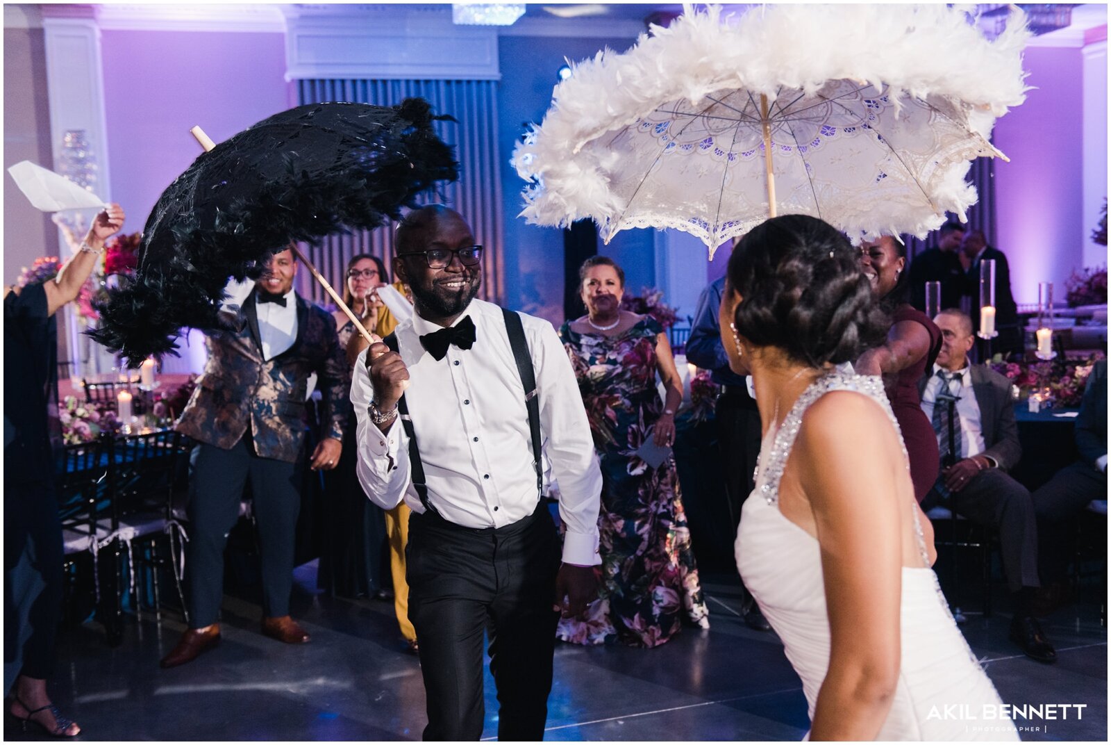 bride and groom holding New Orleans themed Umbrellas  
