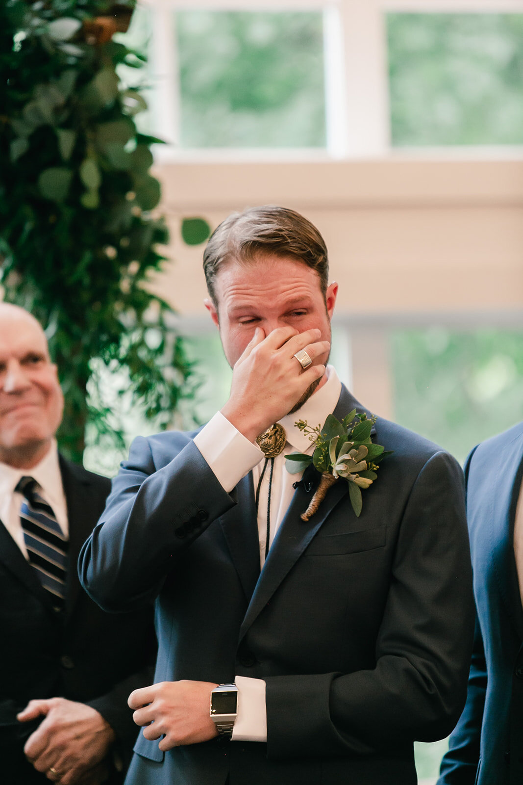  groom tearing up as the bride walks down the aisle 