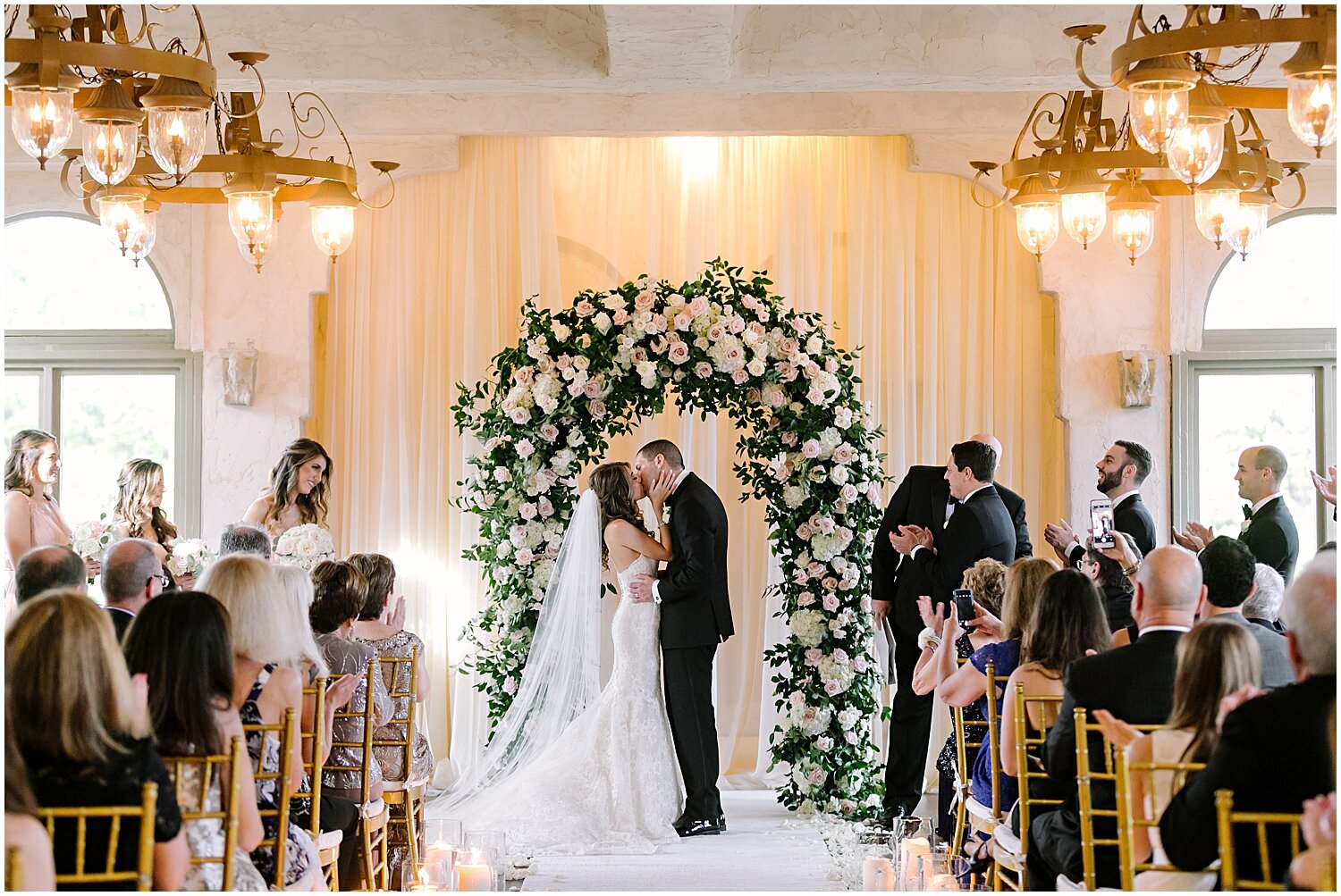  bride and groom kissing at their wedding ceremony 