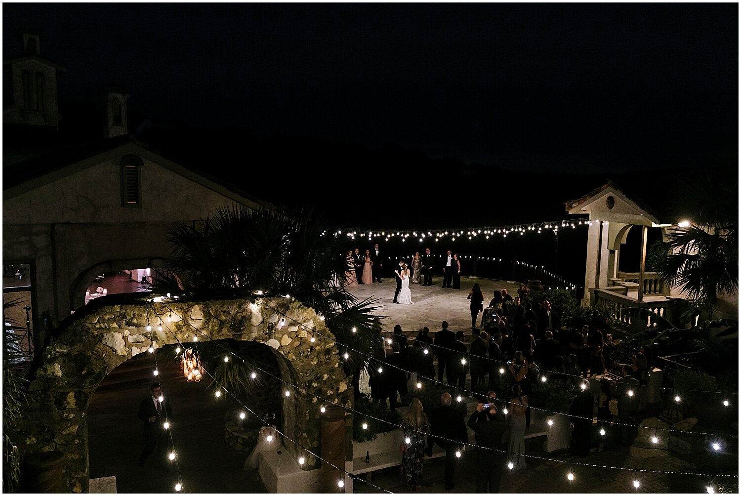  bride and groom’s first dance under string lights 