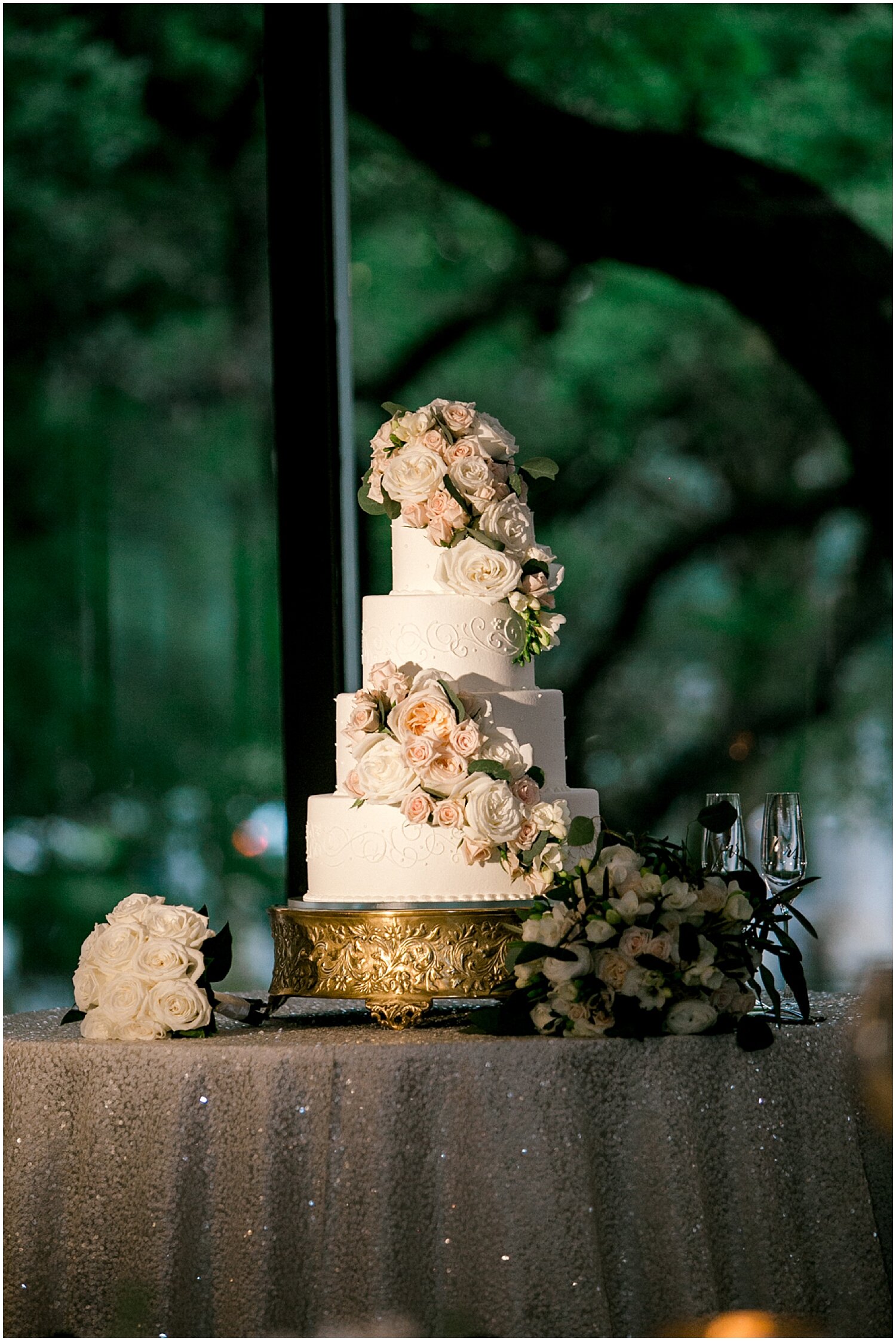  tall white wedding cake with floral decor 