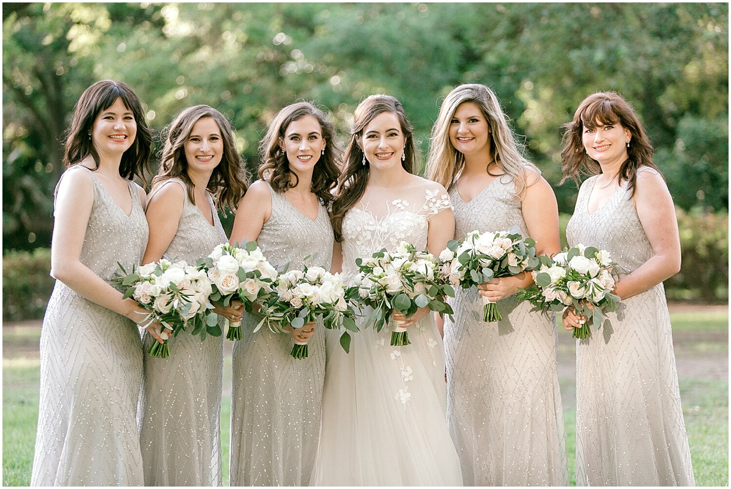  bride and bridesmaids holding their wedding bouquets 