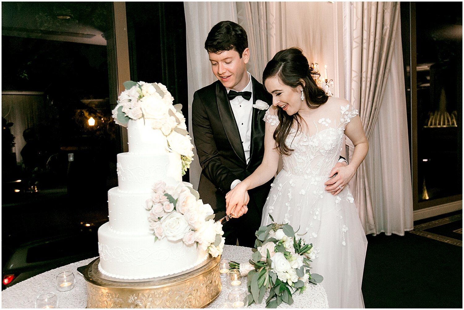  bride and groom cutting their wedding cake 