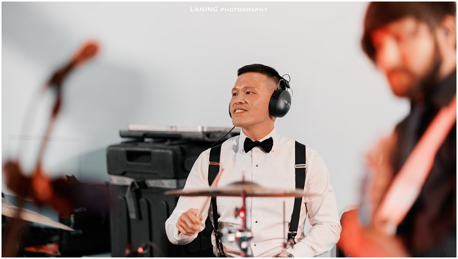  groom playing the drum set during their wedding 