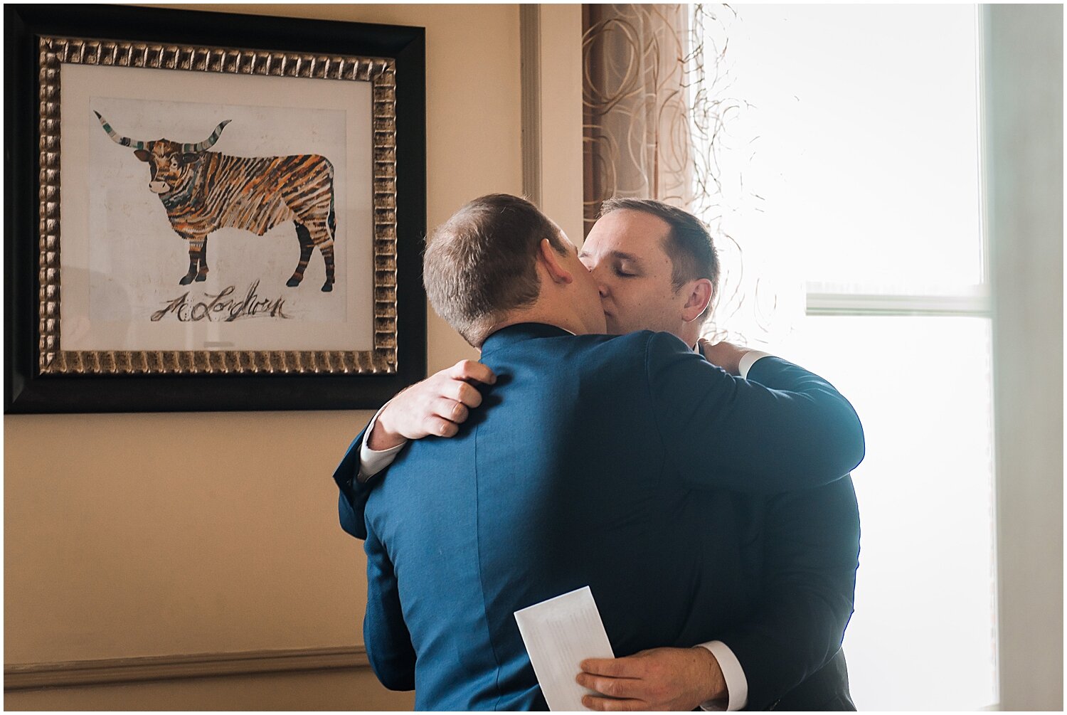  grooms kiss before their wedding ceremony in Houston 