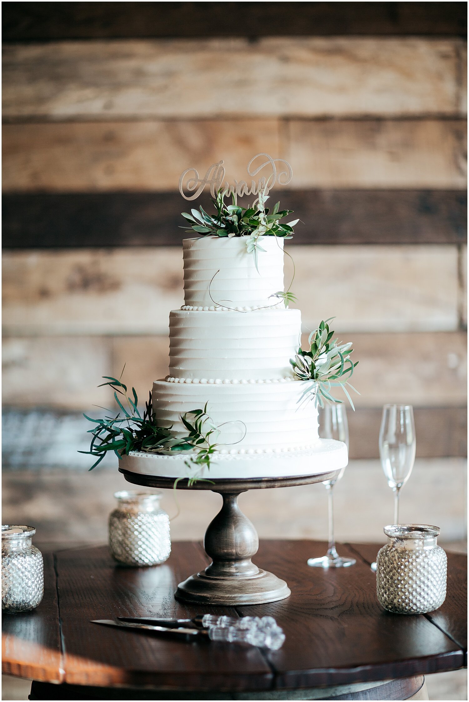  white wedding cake with greenery decor 