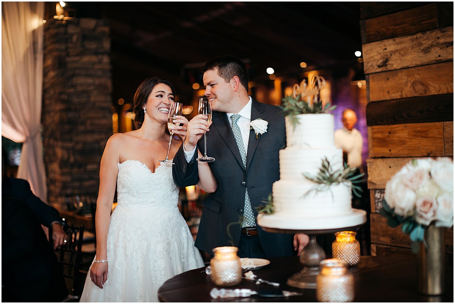  bride and groom making a toast at their wedding reception 